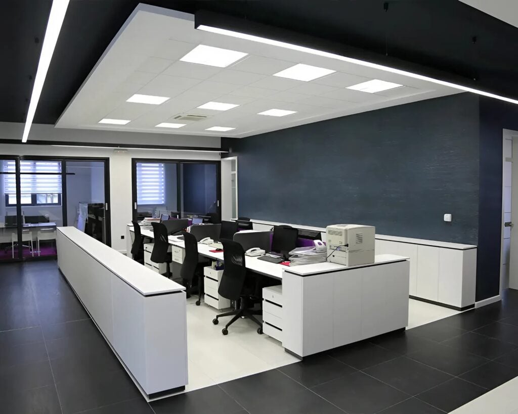 Modern office with charcoal blue wall paint and crisp white trim by a commercial painter in Richmond, VA