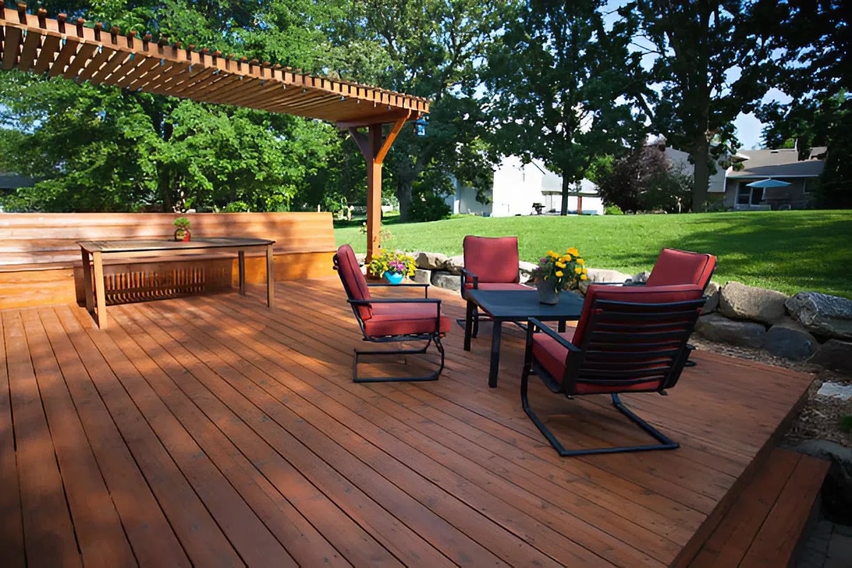 Freshly stained wooden backyard deck with outdoor seating area restored by a painter in Richmond, VA
