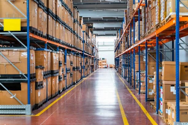 Clean warehouse with organized storage racks, polished floors, and marked aisles by a painter in Powhatan, VA.